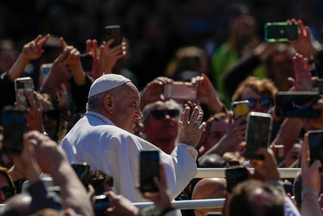 Pope Francis waves from his popemobile to the faithful gathered in St Peter’s Square at the Vatican at the end of the Easter Sunday Mass 