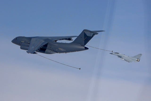 A fighter jet refuels in mid-air