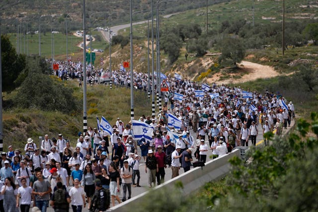 People march to the outpost of Eviatar in the West Bank
