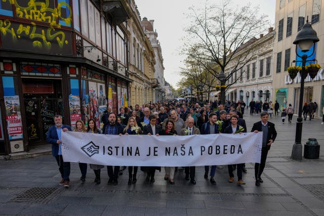 Serbian journalists hold a banner reading “Truth is our victory” as they march to mark the 24th anniversary of the killing of Slavko Curuvija