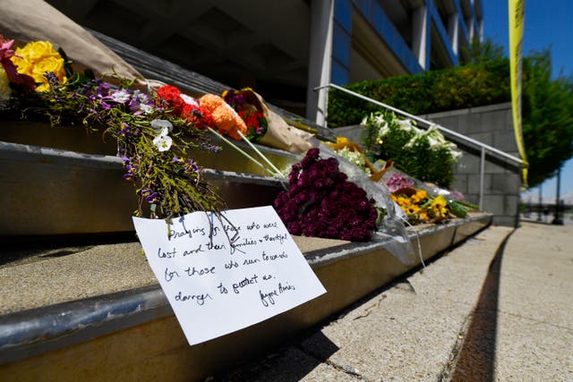 Flowers and a message of hope sit on the steps of the Old National Bank on Tuesday