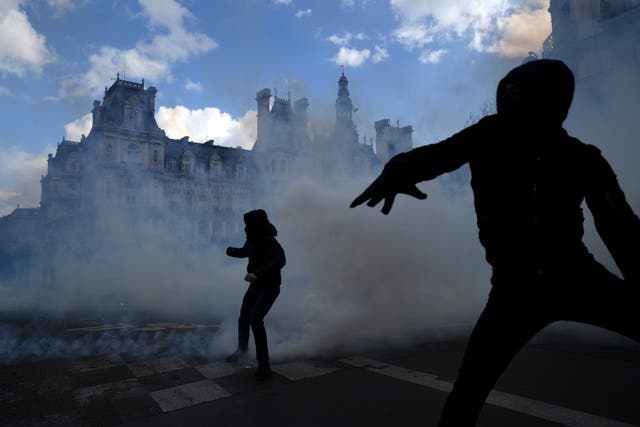 Youths scuffle with police in Paris during a demonstration in Paris on April 13
