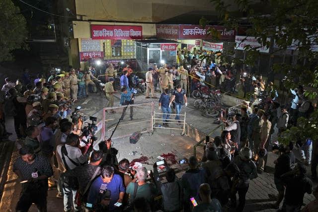 Police and media surround the area where Atiq Ahmad and his brother Ashraf were shot in front of the Motilal Nehru medical college in, Prayagraj, India 