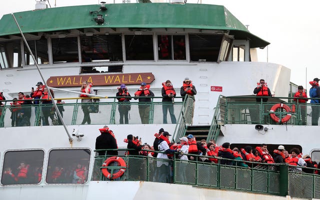 Passengers aboard the Walla Walla passenger ferry gather on the bow after the vessel ran aground near Bainbridge Island west of Seattle 