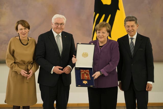 German President Frank-Walter Steinmeier, second left, and his wife Elke Buedenbender, left, pose with former chancellor Angela Merkel, second right, and her husband Joachim Sauer, right, during a reception to honour Mrs Merkel with the Grand Cross of the Order of Merit of the Federal Republic of Germany in a special design at Bellevue Palace in Berlin, Germany 