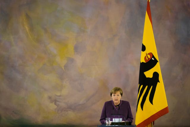 Former German chancellor Angela Merkel speaks after she received the Grand Cross of the Order of Merit of the Federal Republic of Germany in a special design from German President Frank-Walter Steinmeier, during a reception at Bellevue Palace in Berlin, Germany