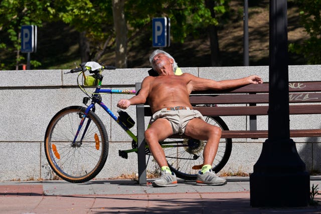 A man sunbathes on a hot spring day in Madrid 