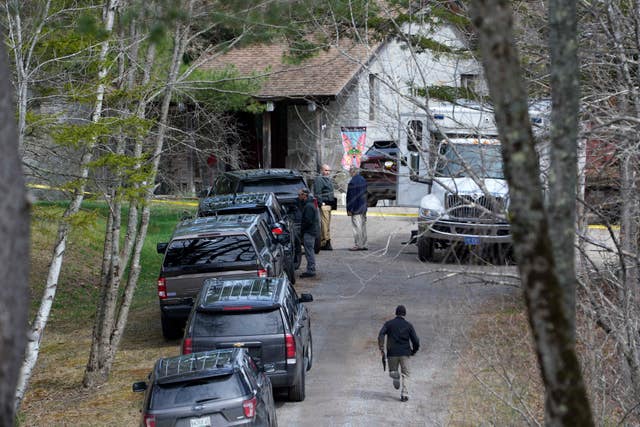 Investigators work at the scene of a deadly shooting in Bowdoin, Maine