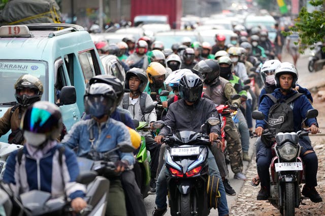 People on motorcycles head to their home villages, leaving from Jakarta, Indonesia 
