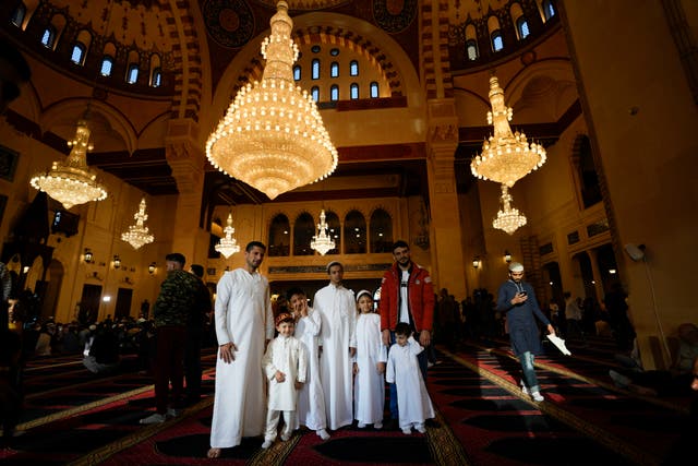 Worshippers pose for a photograph after offering Eid prayers at the Mohammad al-Amin Mosque in downtown of Beirut, Lebanon