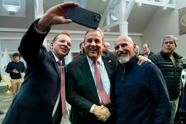 Chris Christie, centre, poses for a selfie after a town hall-style meeting at New England College in April in Henniker, New Hampshire