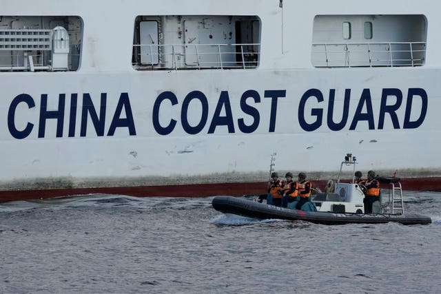 A Chinese coastguard ship deploys crew on motor boats to monitor activities from two Philippine coastguard vessels near the Second Thomas Shoal