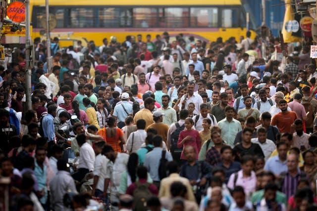 People throng a marketplace in Mumbai, India 