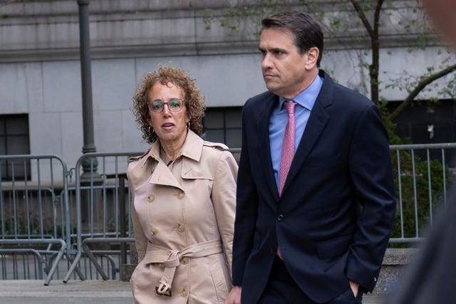 Mr Trump’s lawyer Susan Necheles, left, walks into the courthouse