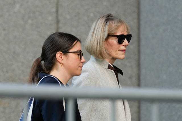 Former advice columnist E Jean Carroll, right, walks into Manhattan federal court on Tuesday