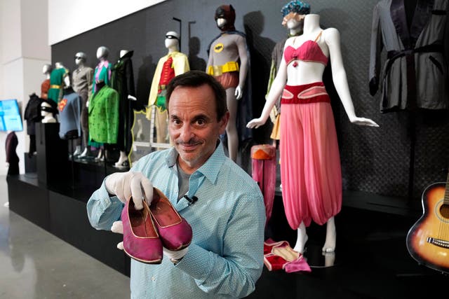 James Comisar holds a pair of shoes once used by Barbara Eden in I Dream Of Jeannie
