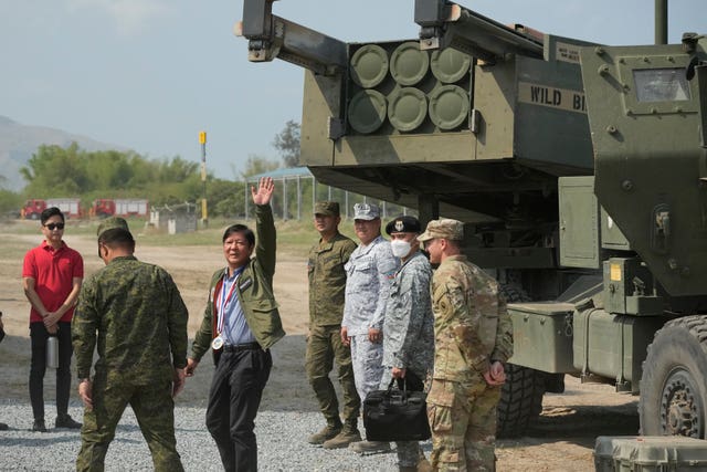 Philippine president Ferdinand Marcos Jr walks beside a US M142 High Mobility Artillery Rocket System during the joint military exercise 