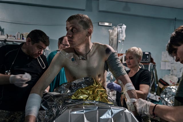 Military medics give first aid to a wounded soldier at a medical stabilisation point near Bakhmut, Donetsk region