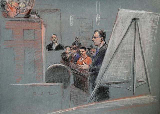 Jack Teixeira, centre, is seated as defence lawyer Brendan Kelley stands and speaks