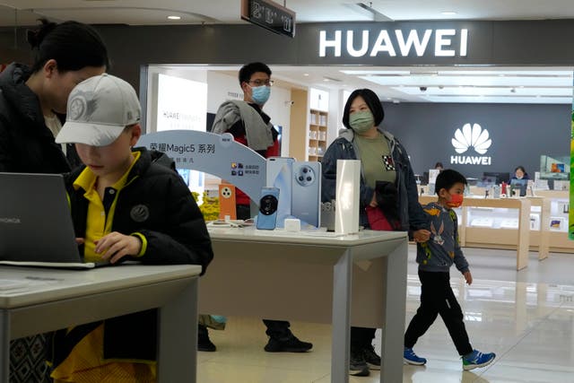 People visit a Huawei shop in Beijing