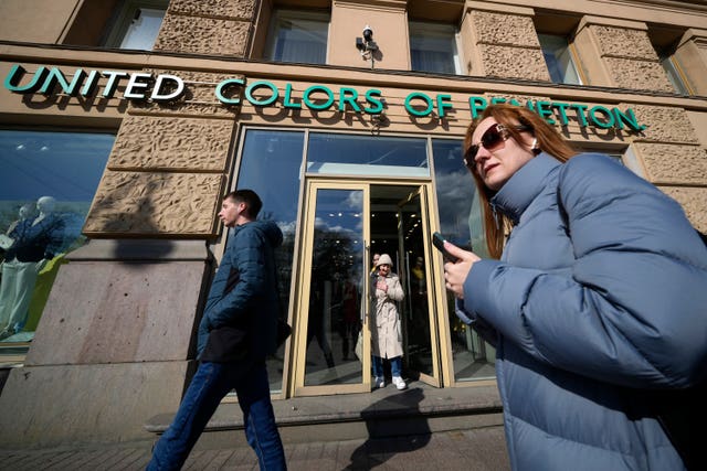 People walk past United Colours of Benetton in St Petersburg, Russia