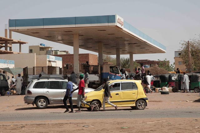 People line up at a petrol station in Khartoum, Sudan