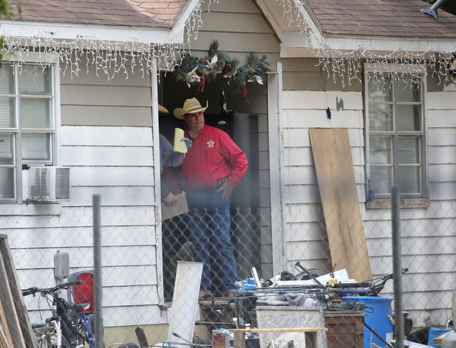 San Jacinto County Sheriff Greg Capers talks to investigators at the scene where five people were shot and killed