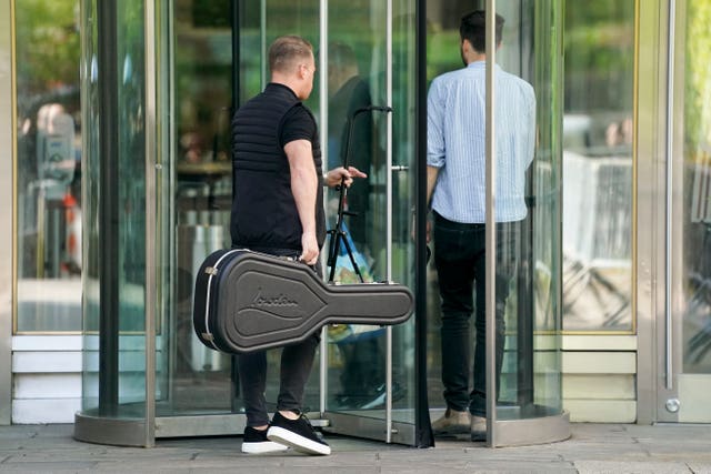 The entourage of recording artist Ed Sheeran arrives at court carrying a guitar case as proceedings continue in his copyright infringement trial in New York