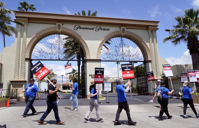 Members of the Writers Guild of America West picket at an entrance to Paramount Pictures in Los Angeles