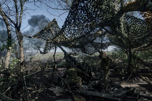 Ukrainian soldiers fire a cannon near Bakhmut 
