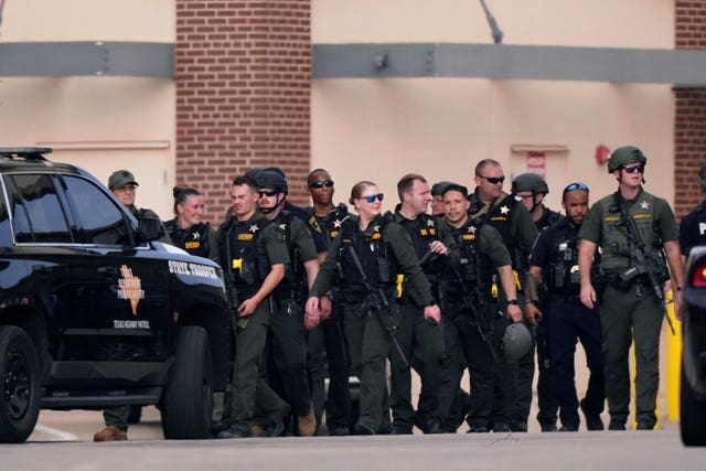 Law enforcement officers at a shopping center after a shooting Saturday, May 6, 2023, in Allen, Texas