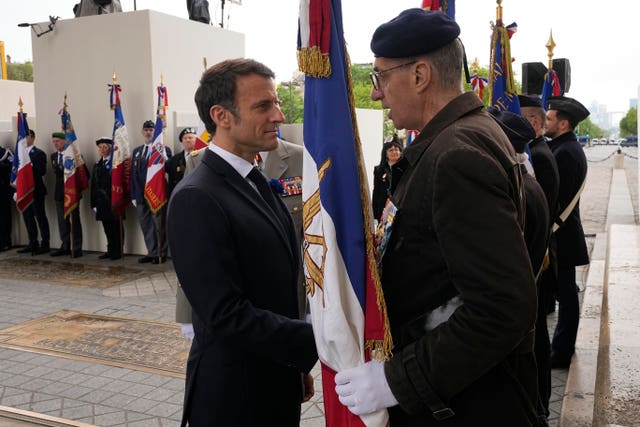 French President Emmanuel Macron meets war veterans during ceremonies marking Victory Day in Paris 