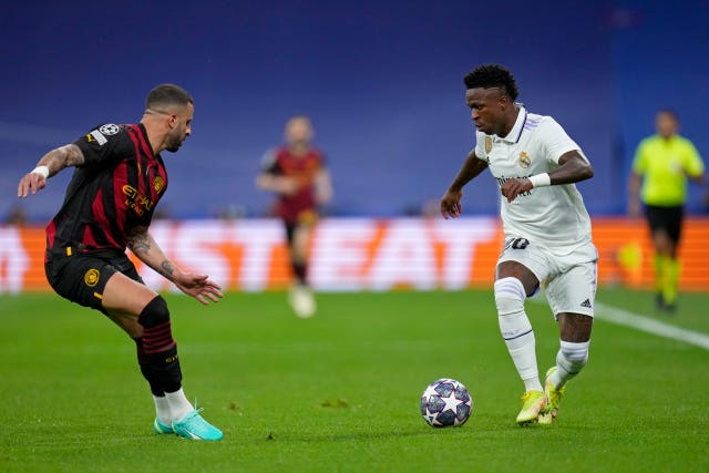 Kyle Walker goes up against Vinicius Junior at the Bernabeu