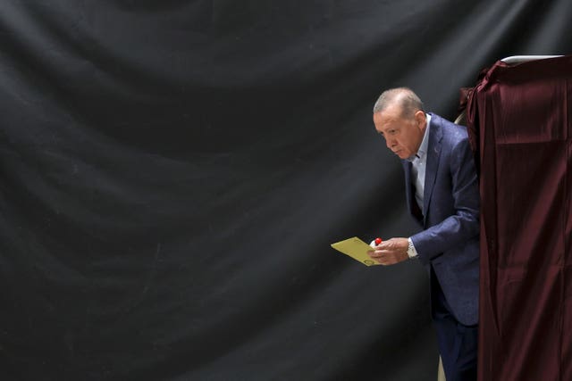 Turkish president Recep Tayyip Erdogan leaves a voting booth at a polling station in Istanbul 