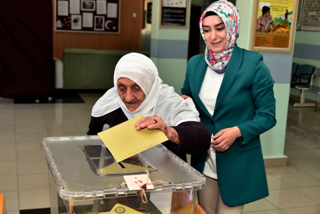 112-year-old Gullu Dogan votes at a polling station in Gumushane 