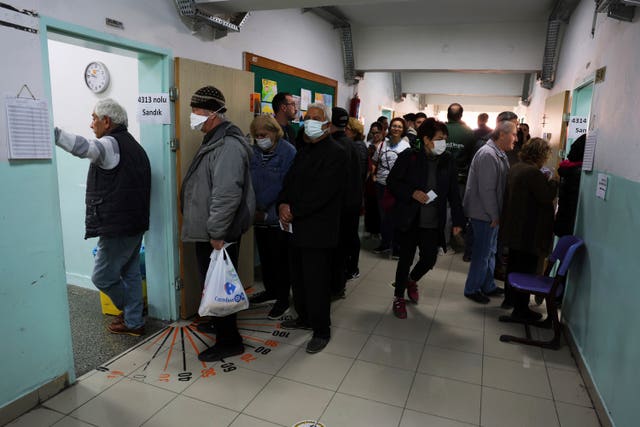 People queue to vote at a polling station in Ankara 