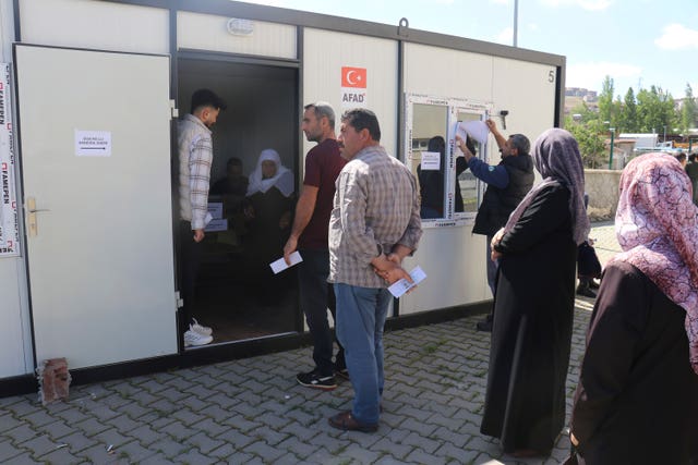 People wait outside containers to vote in earthquake-hit Malatya 