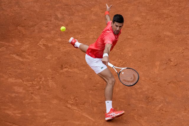 Novak Djokovic slides into a backhand