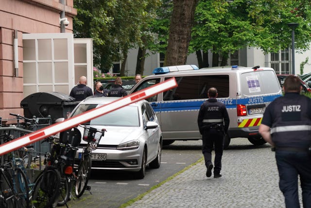 Judiciary vans, each carrying defendants, drive in a courtyard before the start of the trial against members of the United Patriots group at the Higher Regional Court in Koblenz, Germany