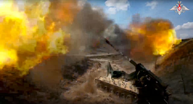 A Russian 152mm self-propelled gun fires towards a Ukrainian position from an undisclosed location