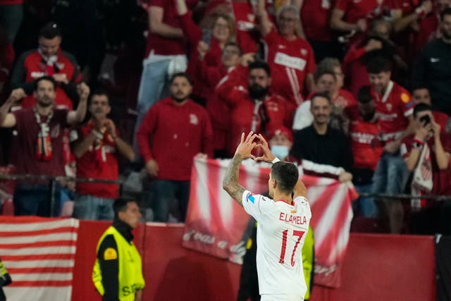 Sevilla’s Erik Lamela signals to the fans after scoring the winning goal 