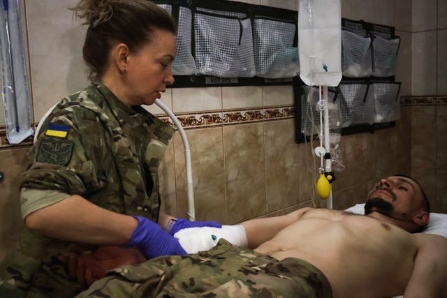 Military medics give first aid to wounded Ukrainian soldiers at a medical stabilisation point near Bakhmut, Donetsk region, Ukraine