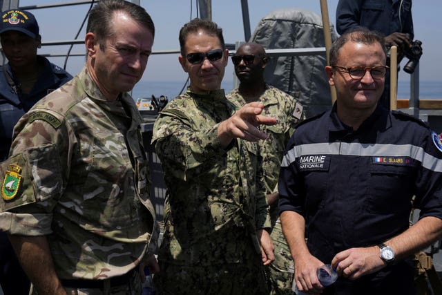 From left, Commodore Philip Dennis, commander of the United Kingdom Maritime Component Command, Vice Admiral Brad Cooper of the US Navy’s Middle East-based 5th Fleet and Vice Admiral Emmanuel Slaars, joint commander of the French forces deployed in the Indian Ocean, look out from the USS Paul Hamilton in the Strait of Hormuz