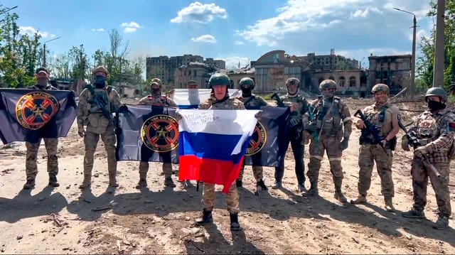 Yevgeny Prigozhin, the head of the Wagner Group military company, speaks holding a Russian national flag in front of his soldiers in Bakhmut, Ukraine