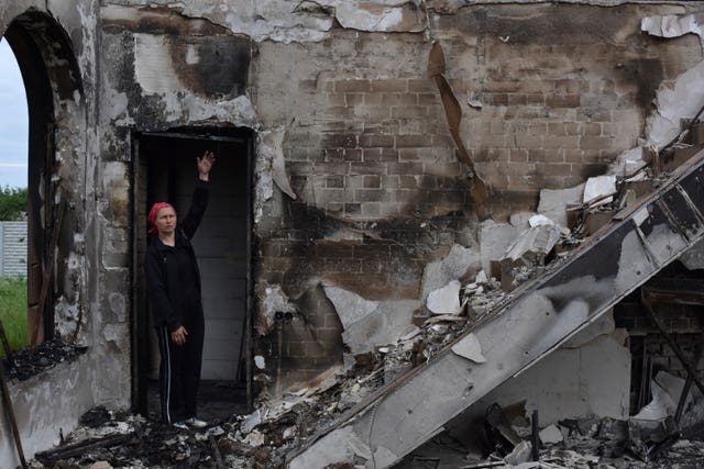 Valentina, 53, a local woman, stands inside of Evangelical Christian Baptists prayer house which was destroyed yesterday by a Russian attack in Orihiv, Ukraine 
