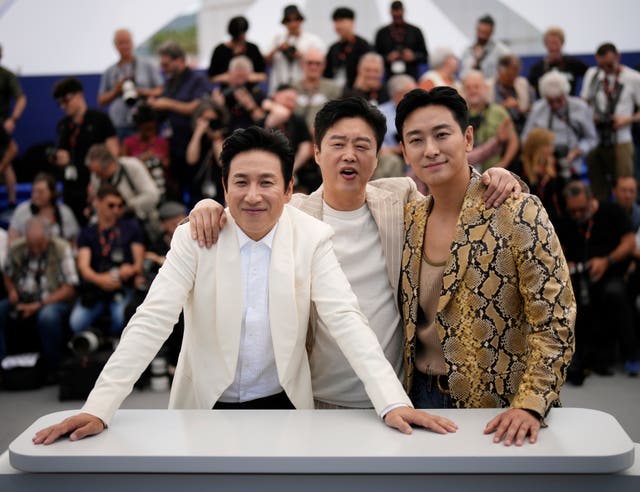 Lee Sun-kyun, from left, Kim Hee-won and Ju Ji-hoon at the photo call for the film Project Silence at the 76th international film festival, Cannes, southern France, on May 22 2023 