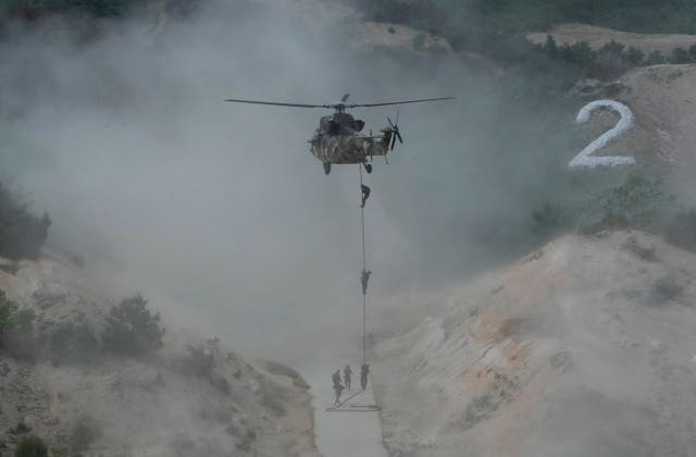 South Korean army soldiers rope down from a Surion helicopter during South Korea-US joint military drills at Seungjin Fire Training Field in Pocheon, South Korea
