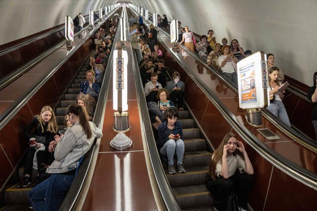 People take cover at metro station during a Russian rocket attack in Kyiv