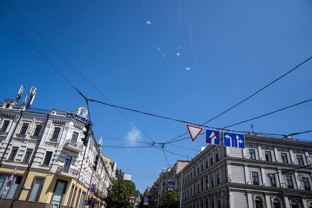 Tracks and white smoke are seen in the sky during Russian rocket attack in Kyiv