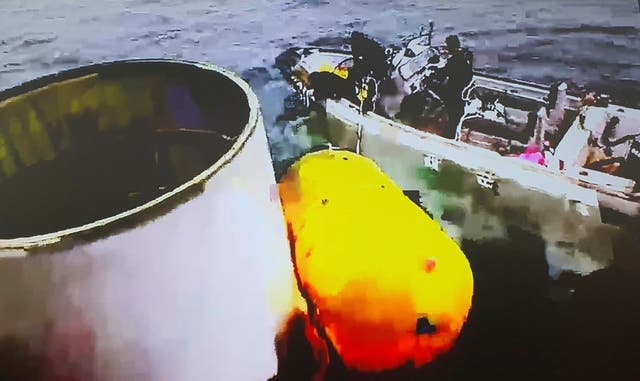 This photo provided by South Korea’s Defense Ministry, shows an object, left, salvaged by South Korea’s military that is presumed to be part of the North Korean space-launch vehicle that crashed into sea following a launch failure in waters off Eocheongdo island, South Korea on Wednesday, May 31, 2023